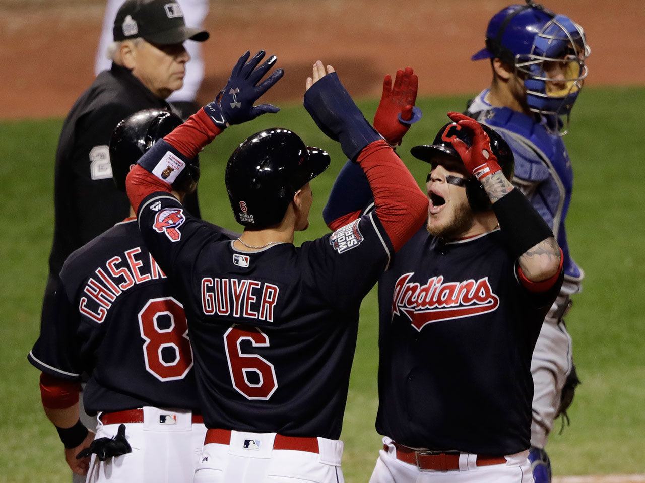 The Indians’ Roberto Perez celebrates with Brandon Guyer (6) and Lonnie Chisenhall (8) after hitting a three-run home run during the eighth inning of Game 1 of the World Series against the Cubs Tuesday in Cleveland. (AP Photo/Gene J. Puskar)