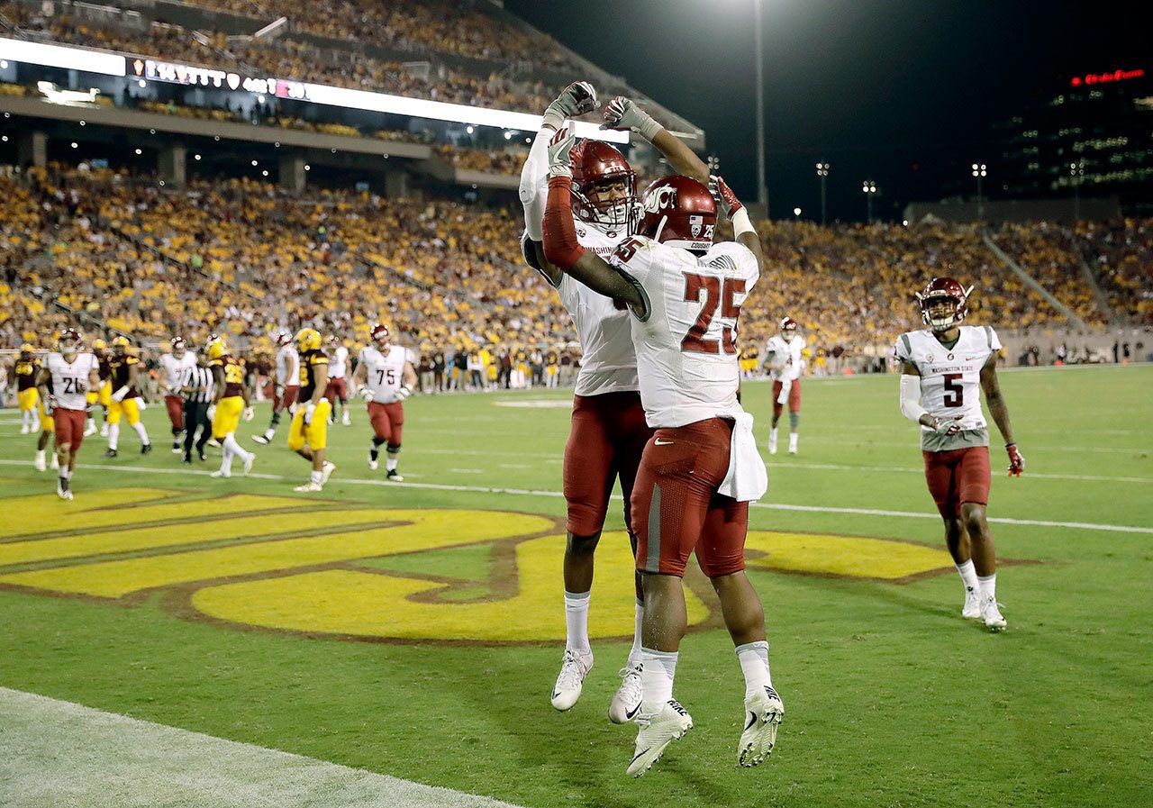 Washington State’s Jamal Morrow (25) celebrates his touchdown catch with teammate Isaiah Johnson-Mack during the Cougars’ victory over Arizona State on Saturday in Tempe, Ariz. (AP Photo/Matt York)