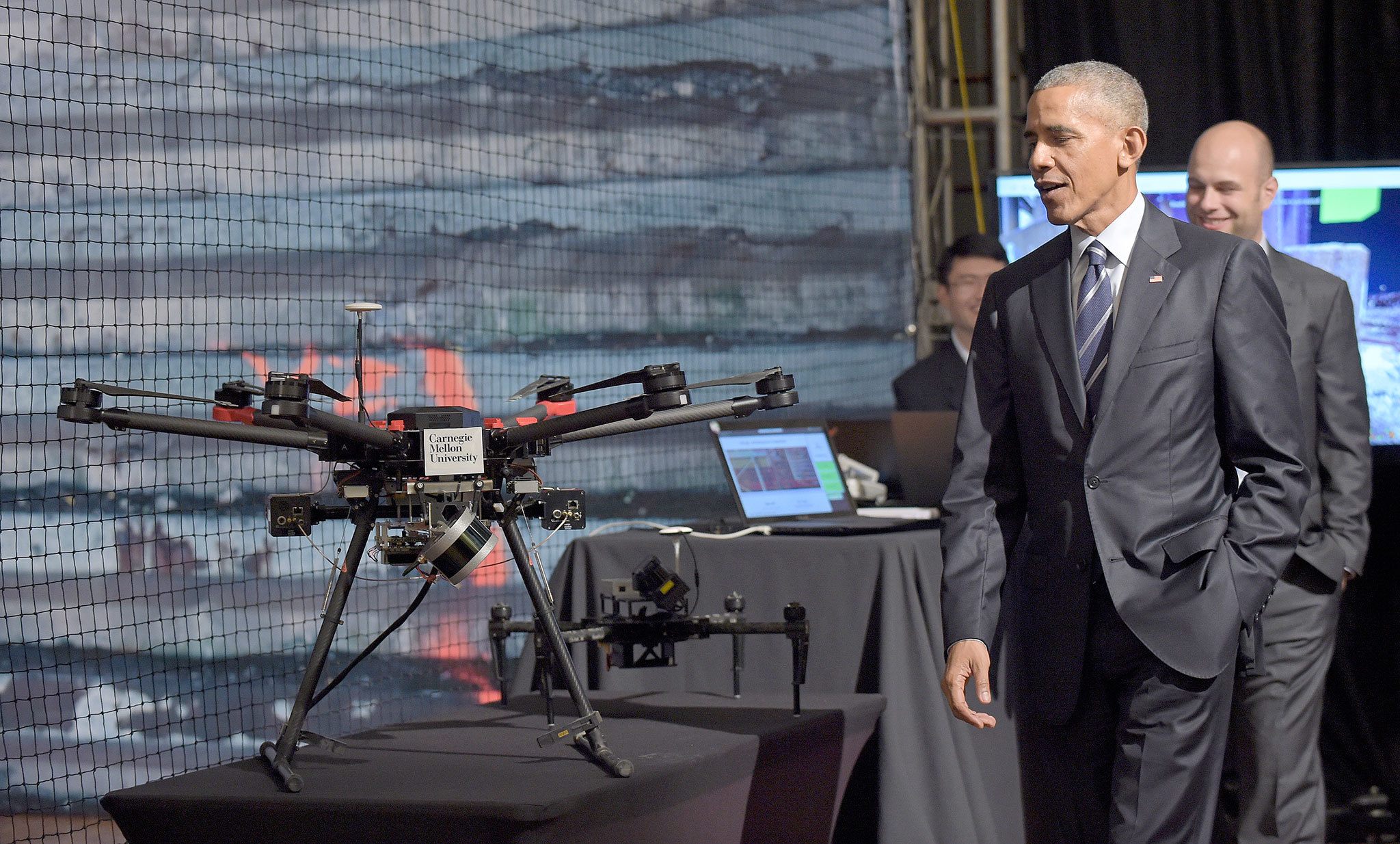 President Barack Obama walks past a drone after a demonstration at the University of Pittsburgh in Pittsburgh on Oct. 13. (AP Photo/Susan Walsh)