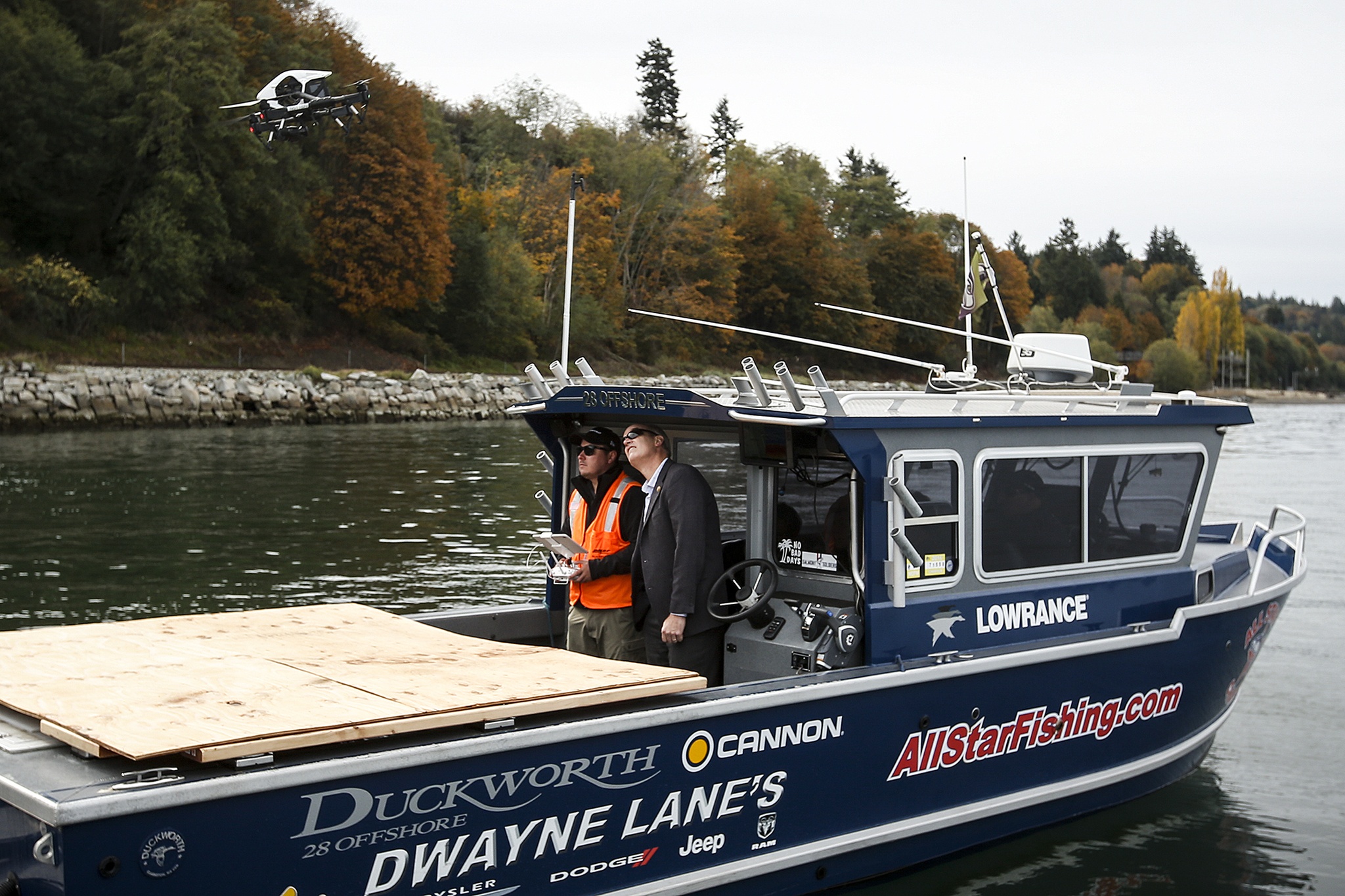 U.S. Rep. Rick Larsen (center) watches as a drone piloted by Burlington Northern and Santa Fe Railway’s Nolan Rubalcaba takes off near a seawall south of downtown Everett on Wednesday morning. BNSF has embraced drone technology and gone through steps to become approved by the FAA for use as a tool to help examine infrastructure and railways. (Ian Terry / The Herald)