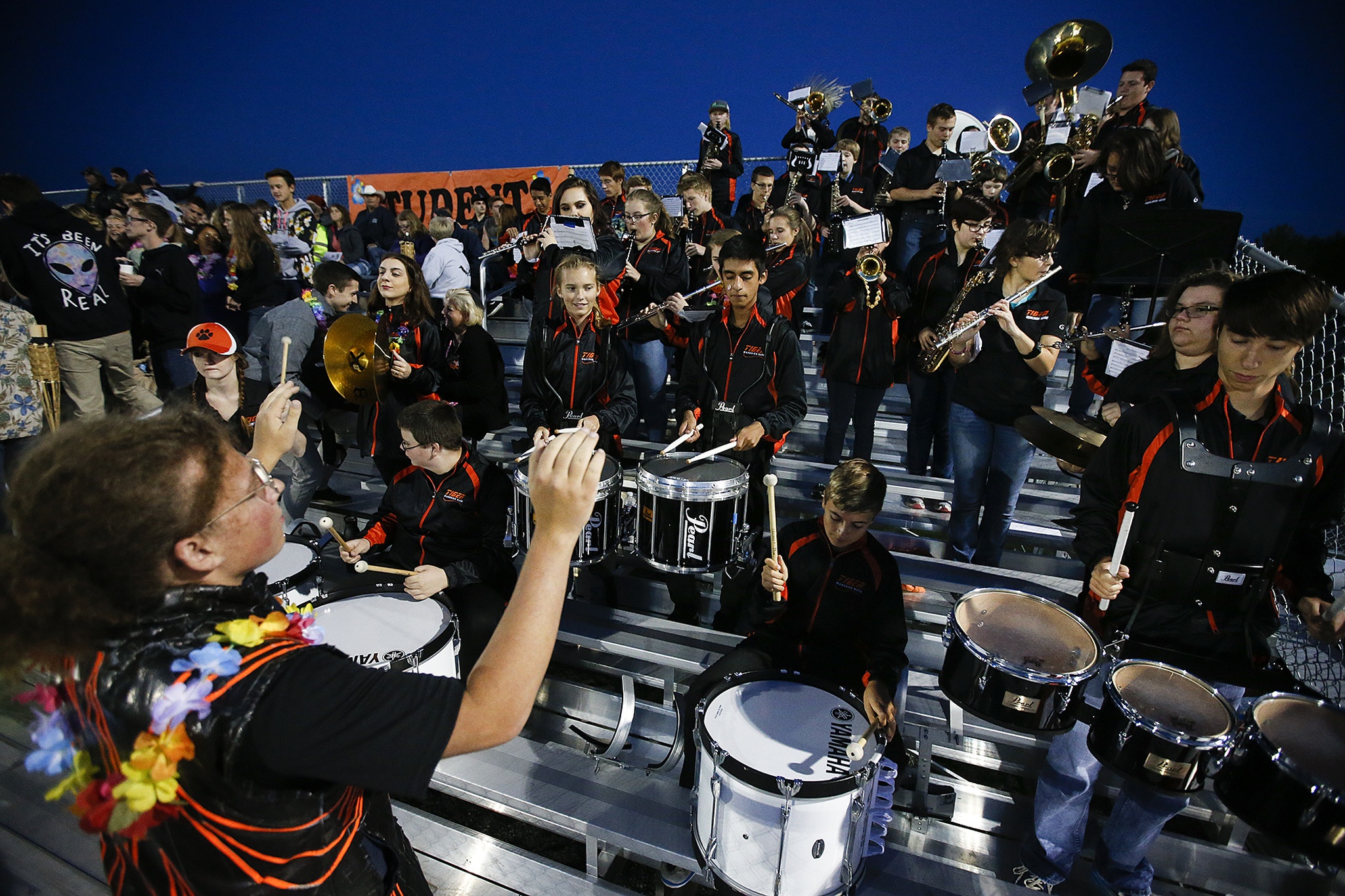 Sage Strecker, drum major for Granite Falls High School, leads the band through a quick tune during a timeout in the first quarter of a football game at the school Friday. The band, students and fans are currently using a temporary grandstand. (Ian Terry / The Herald)
