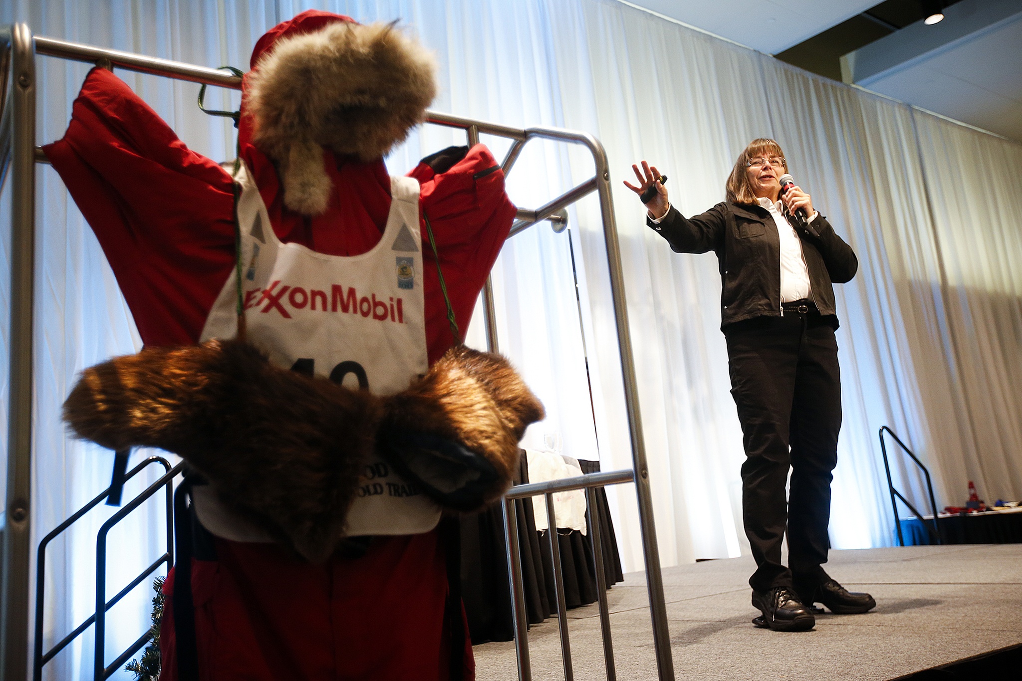 Jan Steves speaks at the 11th annual Domestic Violence Services of Snohomish County luncheon at Xfinity Arena in Everett on Wednesday. Steves, an Edmonds native, spoke to those gathered about the challenges of completing the brutally cold Iditarod sled dog race in Alaska, of losing her 31-year-old son to a heart attack and of rebuilding her home after it was destroyed in an Alaska wildfire. “Victims of domestic violence need to know they are capable of more than they can imagine,” Steves said. (Ian Terry / The Herald)