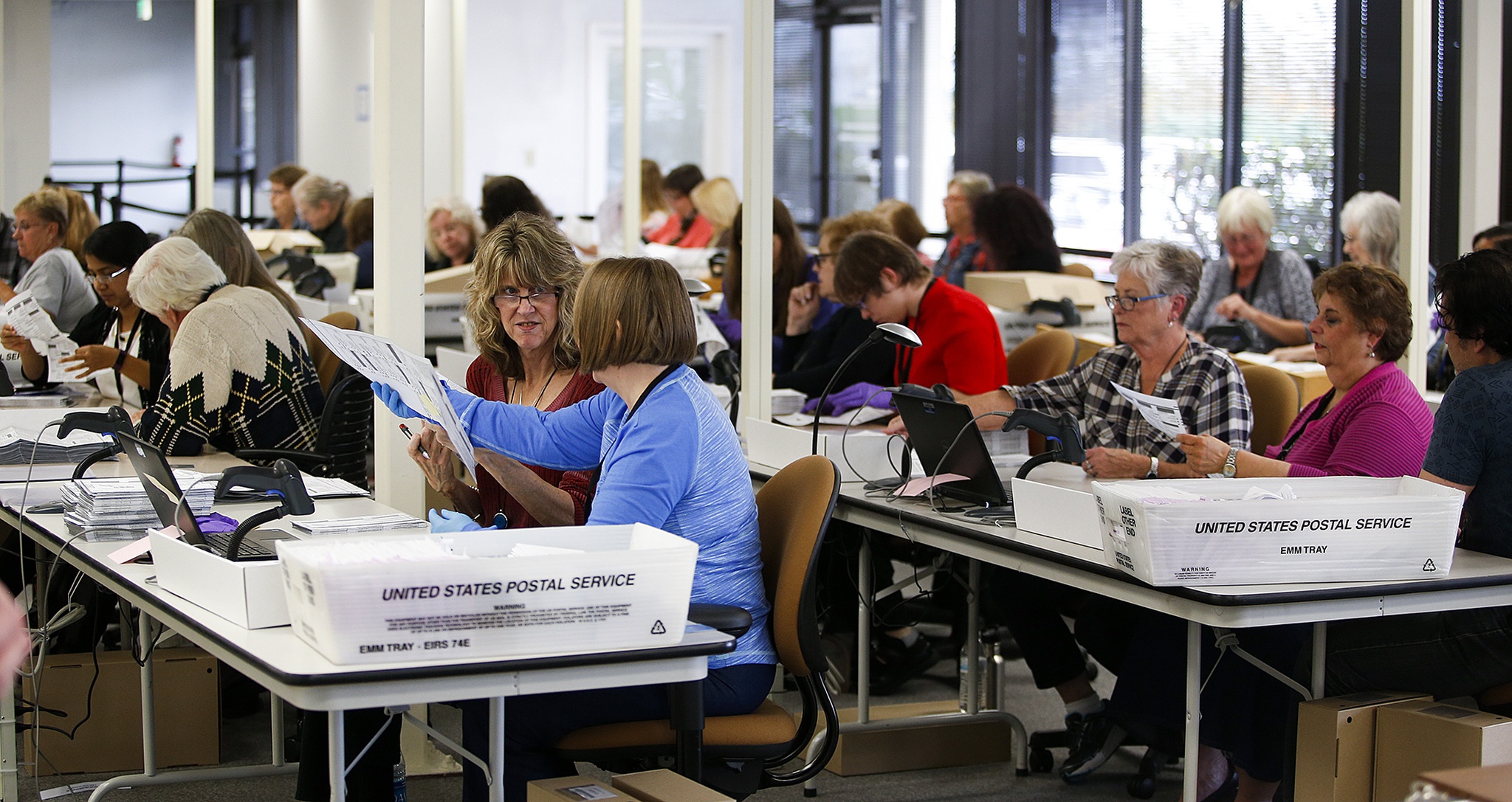Workers inspect, count and organize ballots coming in from Snohomish County mail-in voters at an office across from the Future of Flight museum in Mukilteo on Thursday. The county has almost 250 people employed to handle all aspects of counting this year’s ballots. (Ian Terry / The Herald)
