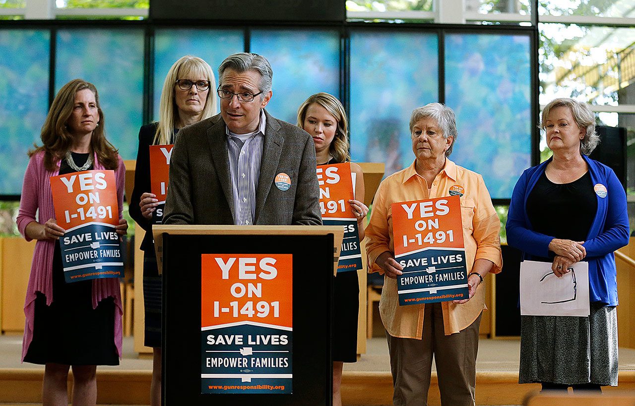 Daniel Weiner, center, Senior Rabbi at Temple De Hirsch Sinai in Bellevue, speaks at Sept. 21 news conference in Bellevue promoting Initiative 1491, which will be on the ballot in the November elections. If passed by voters, the initiative would allow law enforcement or others to obtain court orders to temporarily take guns from people considered a danger to themselves or others. Weiner is a founding member of the Washington Alliance for Gun Responsibility. (AP Photo/Ted S. Warren)