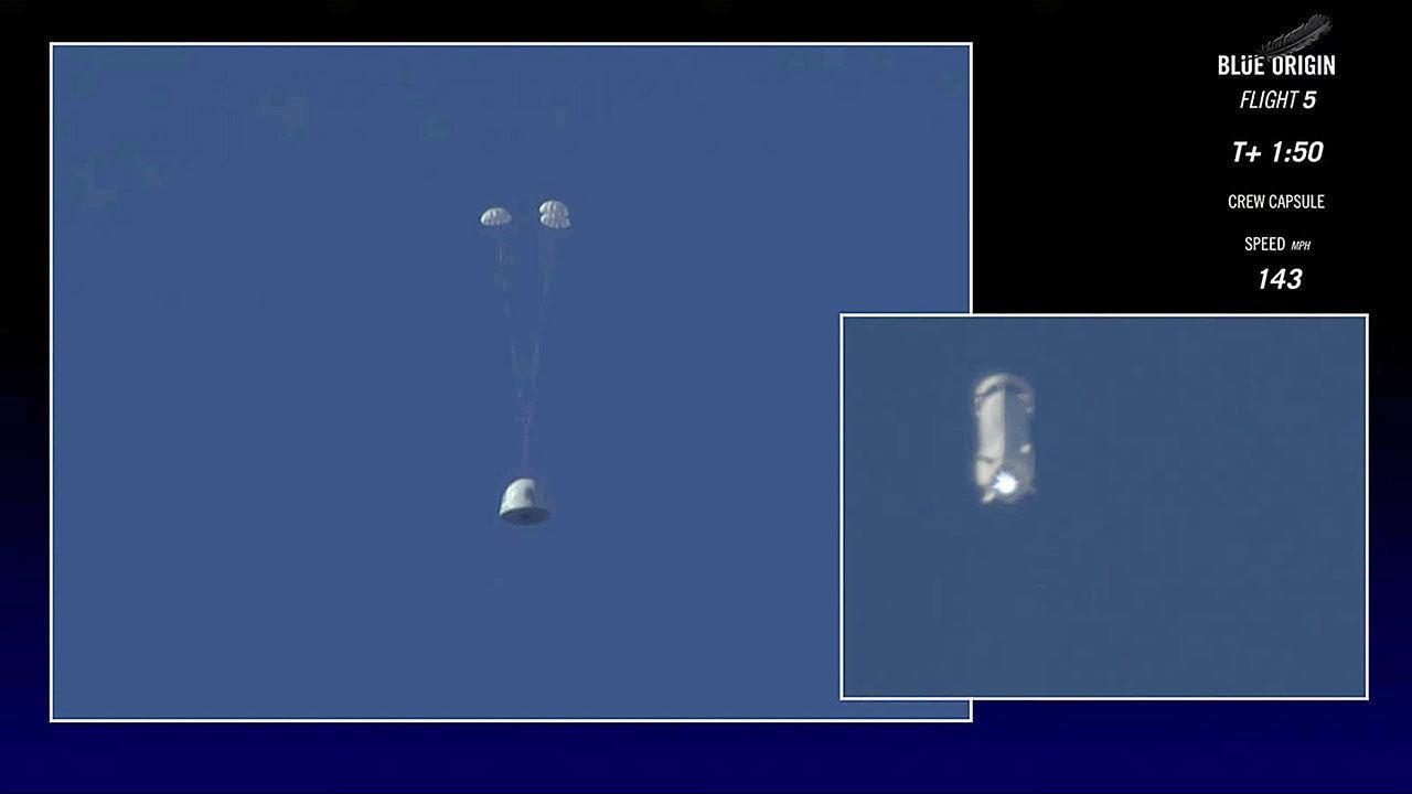 In this image made from video, the New Shepard capsule, left, prepares to return to the ground as its booster rocket continues upwards during a test of the escape system in west Texas on Wednesday. The escape system is designed to save lives if something goes wrong with the rocket during liftoff. (Blue Origin via AP)
