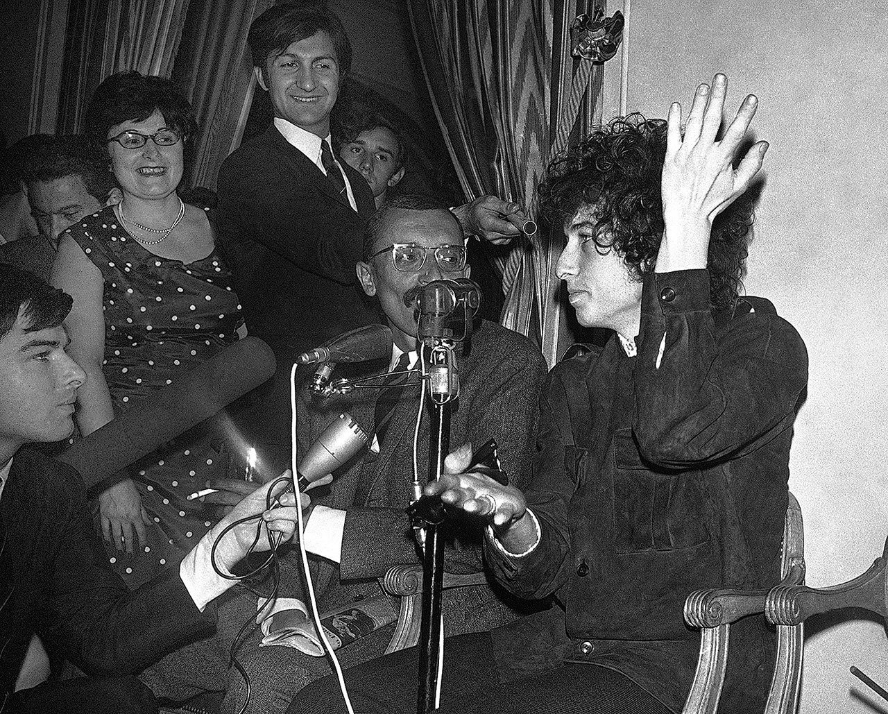 In this May 22, 1966, photo, Bob Dylan gestures during a news conference in Paris, France. Dylan won the 2016 Nobel Prize in literature Thursday, a stunning announcement that for the first time bestowed the prestigious award on a musician for “having created new poetic expressions within the great American song tradition.” (AP Photo/Pierre Godot, File)