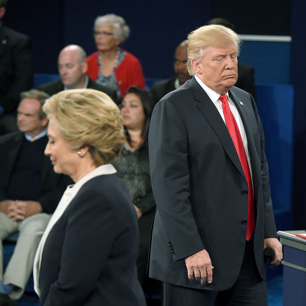 Republican presidential nominee Donald Trump (right) and Democratic presidential nominee Hillary Clinton listen to a question during the second presidential debate at Washington University in St. Louis on Sunday. (Saul Loeb/Pool via AP)