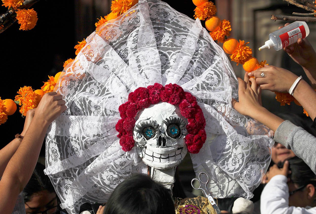 Residents work on a skeleton representation as part of the Day of the Dead festivities in Mexico City on Thursday. (AP Photo/Marco Ugarte)