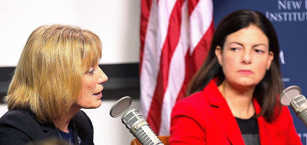 Candidates for U.S. Senate, Democrat Gov. Maggie Hassan, left, and incumbent Republican Sen. Kelly Ayotte, attend a forum with business leaders Tuesday, Oct. 25, in Manchester, New Hampshire. (AP Photo/Jim Cole)
