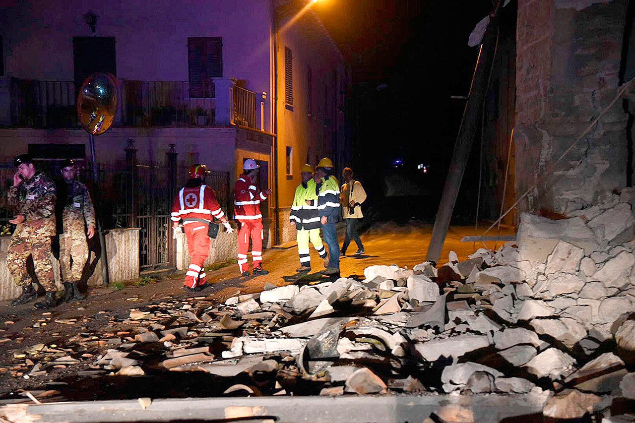 Rescuers stand by rubble in the village of Visso, central Italy, on Wednesday, Oct. 26, following an earthquake. (Matteo Crocchioni/ANSA via AP)