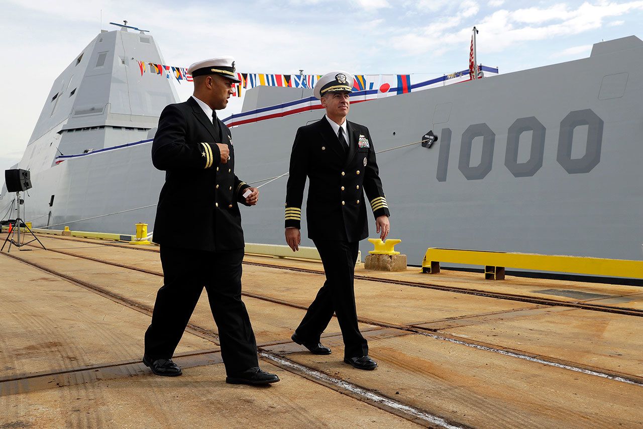 Capt. James Kirk (right), commanding officer of the USS Zumwalt walks past the ship to a news conference in Baltimore on Thursday. (AP Photo/Patrick Semansky)