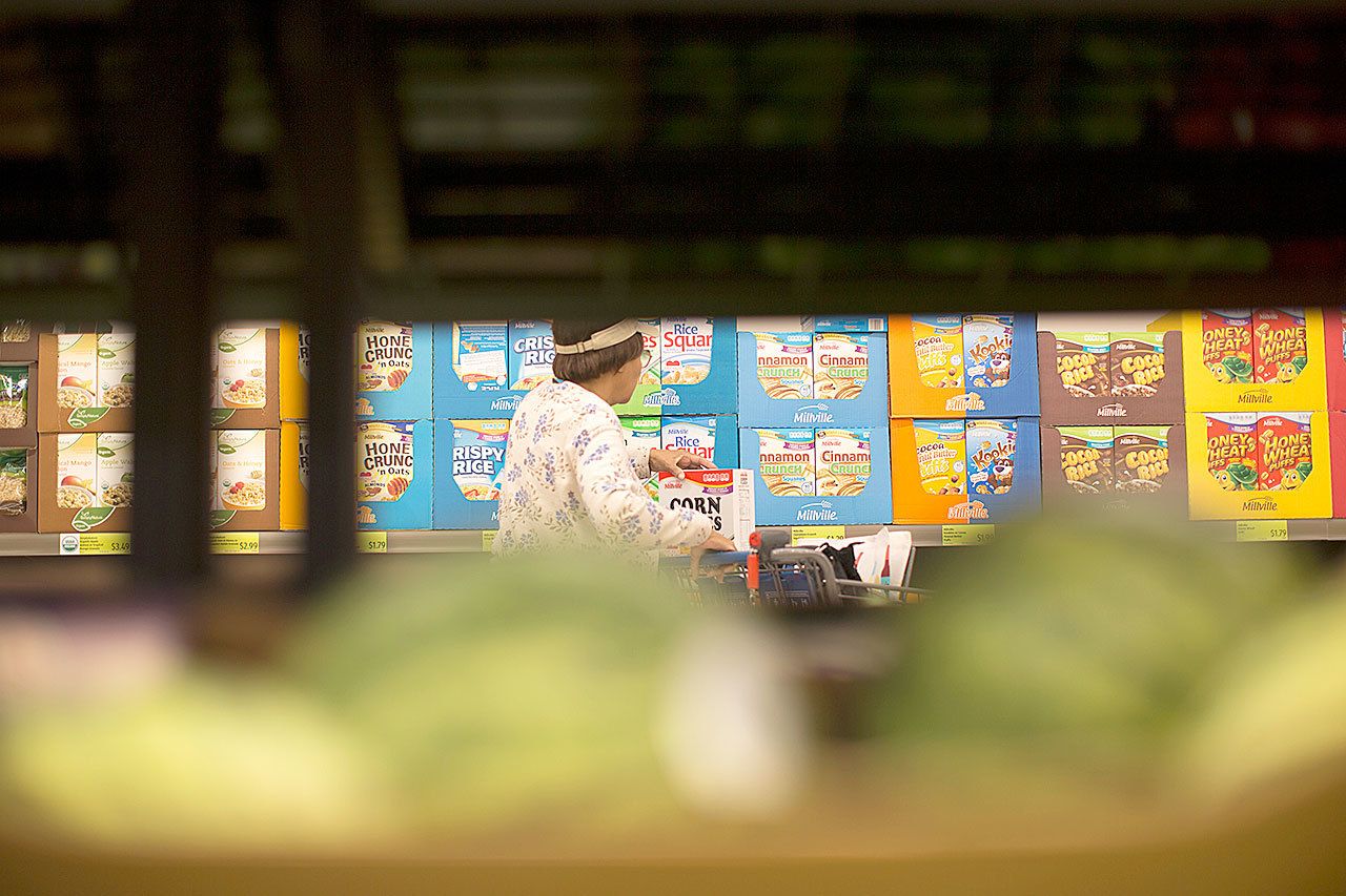 A shopper browses the cereal section at an Aldi food market in Inglewood, California. Sales of cold and hot cereals combined are expected to total $10.6 billion this year, down 17 percent from $12.7 billion in 2009, the research firm IbisWorld estimates. (Gina Ferazzi/Los Angeles Times)