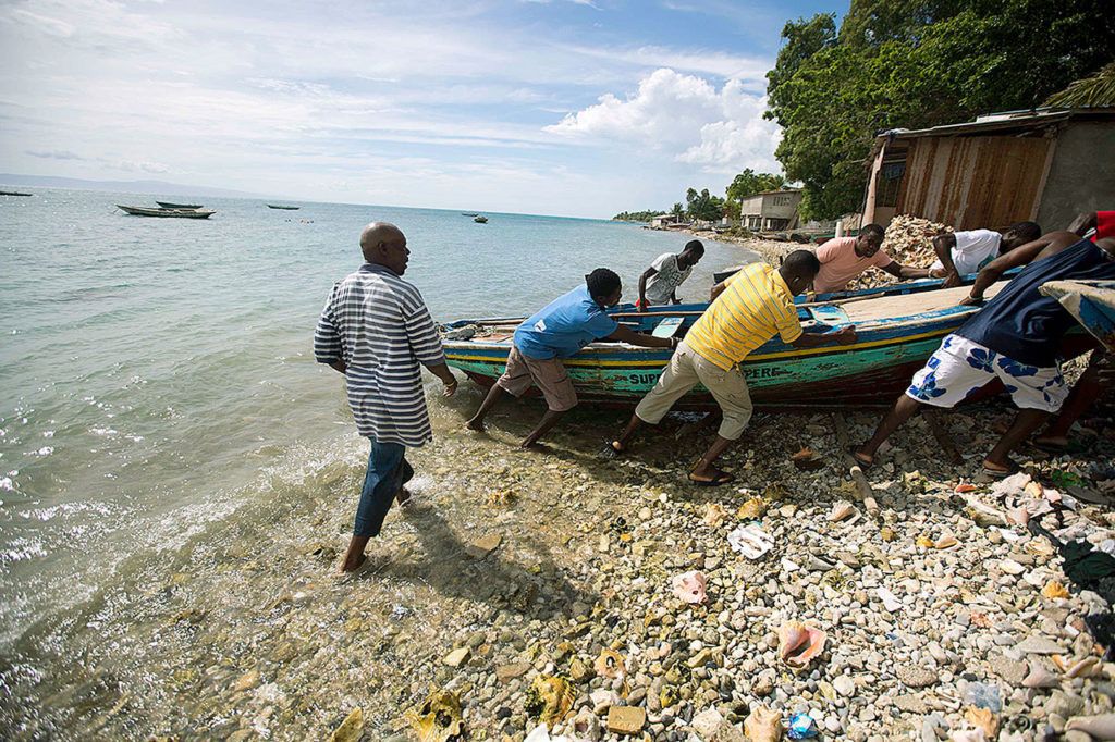 Fishermen move their boats out of the water Sunday before the arrival of Hurricane Matthew in Arcahaie, Haiti. ( AP Photo/Dieu Nalio Chery)
