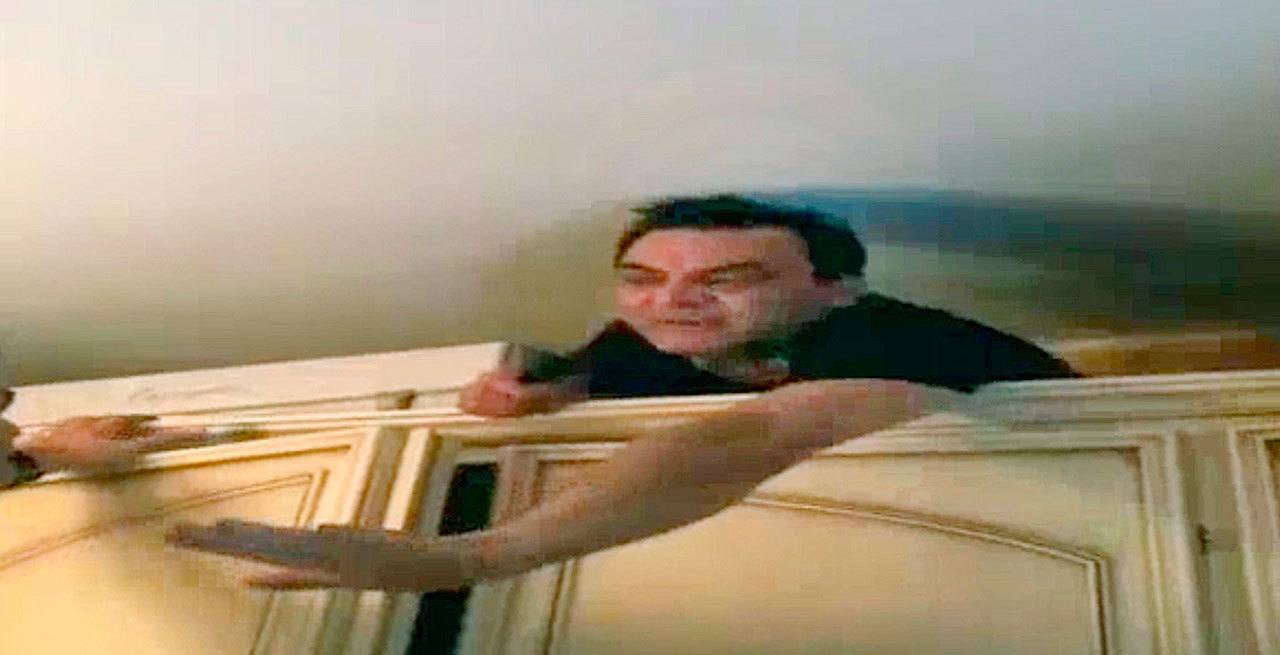 In this image taken from a video fugitive ‘Ndrangheta mob boss Antonio Pelle comes out of the closet to surrender himself after five years on the lam, in Reggio Calabria, Italy, on Wednesday. (Italian Police via AP)