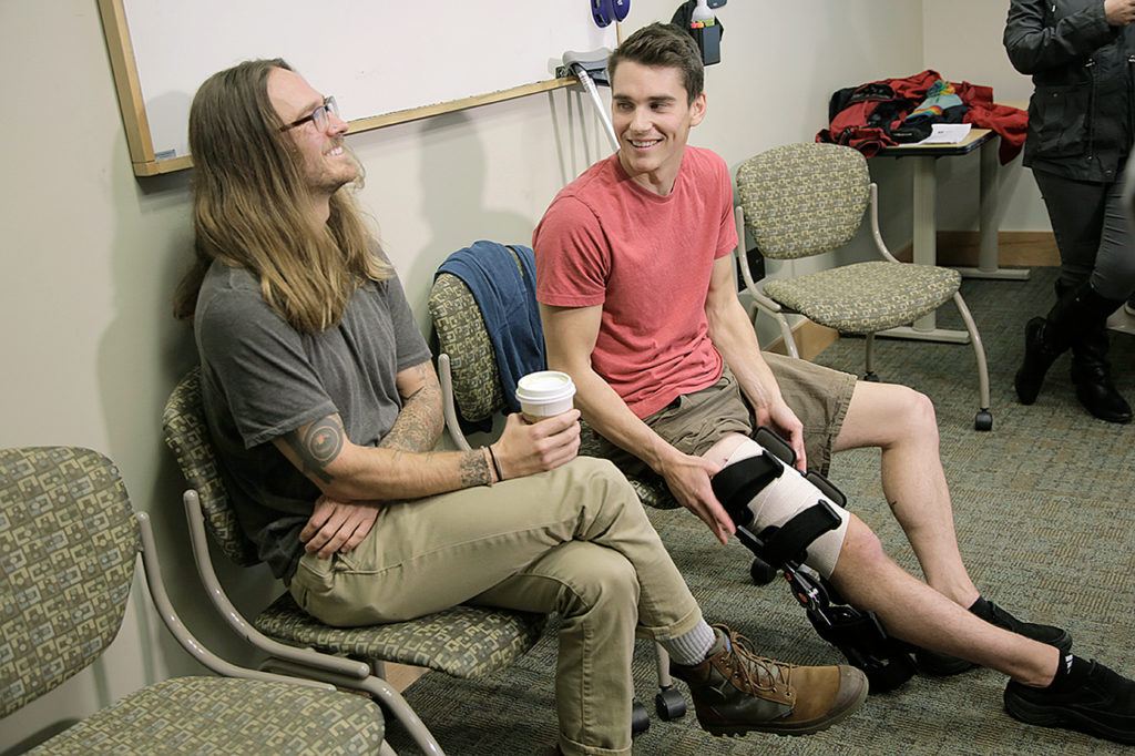 Joseph Tanner (right) survived a shark attack while surfing on the Oregon Coast on Oct. 10. He spoke with media Wednesday at Legacy Emanuel Medical Center, where he is a critical care nurse. With him is West Woodworth, who helped pull Tanner from the ocean. (Stephanie Yao Long / The Oregonian via AP)
