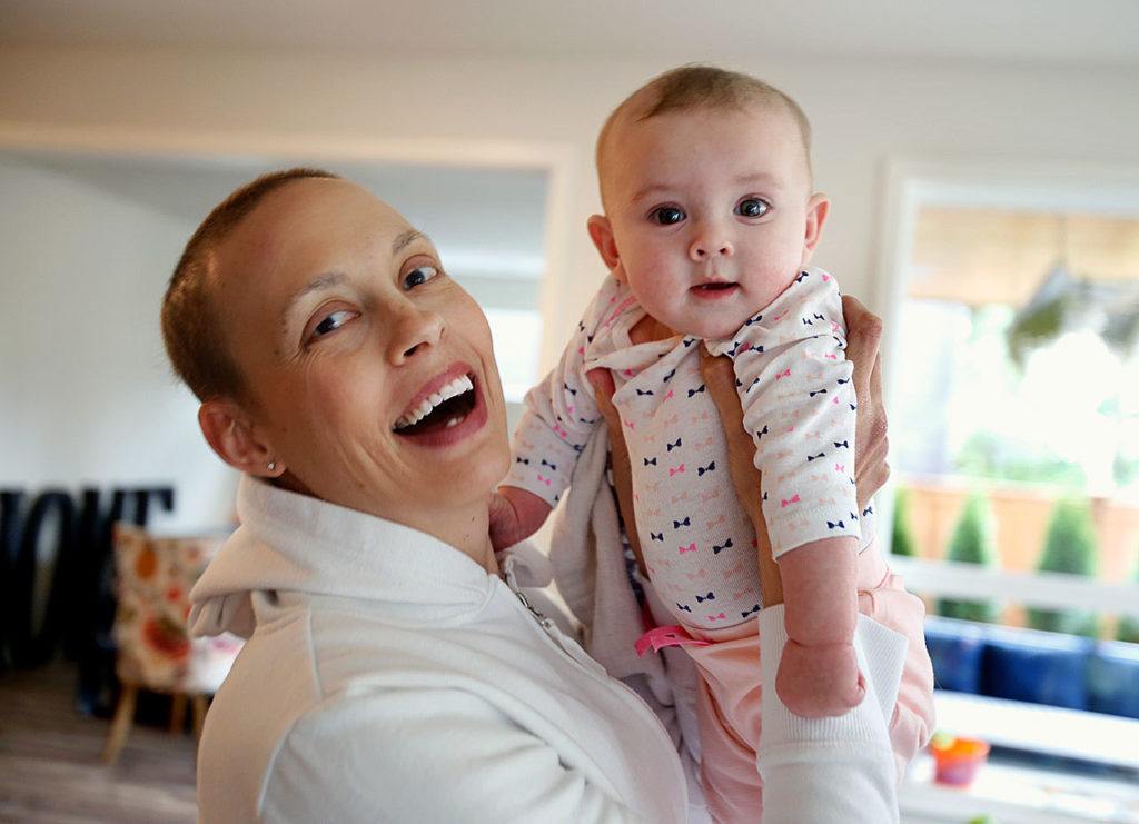 Apryl Roberts joyfully holds up her 4-month-old daughter, Haven, Wednesday at her home in Lynnwood. (Dan Bates / The Herald)
