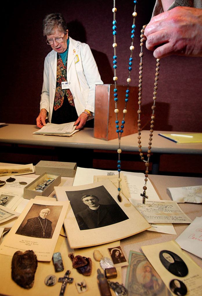 Sister Dorothy Klingele, who served in health care with the Sisters of Providence for many years, looks over treasures from time capsules during the 2005 celebration of the 100th anniversary of what was then Providence Everett Medical Center. Klingele died Oct. 15 at age 90. (Dan Bates / The Herald)
