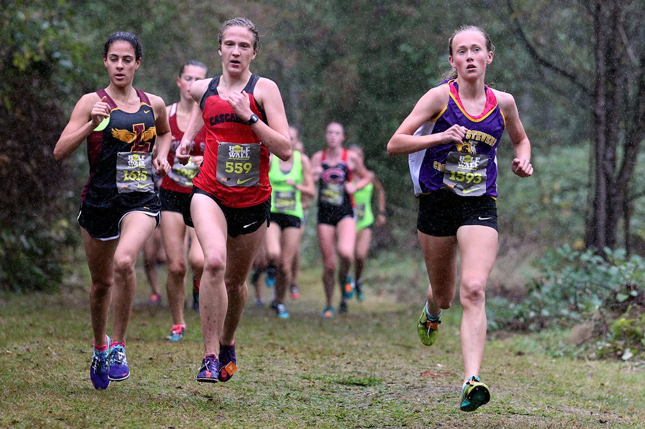 Lake Stevens’ Taylor Roe (far right) leads the pack on her way to finishing second at the Hole in the Wall Invite Saturday at Lakewood High School. (Kevin Clark / The Herald)