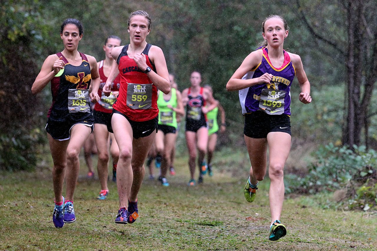Lake Stevens’ Taylor Roe (far right) leads the pack on her way to finishing second at the Hole in the Wall Invite Saturday at Lakewood High School. (Kevin Clark / The Herald)