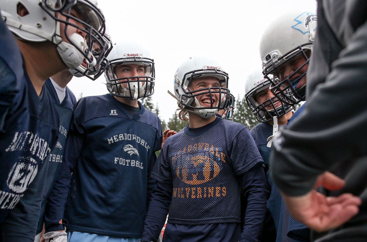 Members of the Meadowdale offense huddle during practice Thursday afternoon at Meadowdale High School in Lynnwood. (Kevin Clark / The Herald)