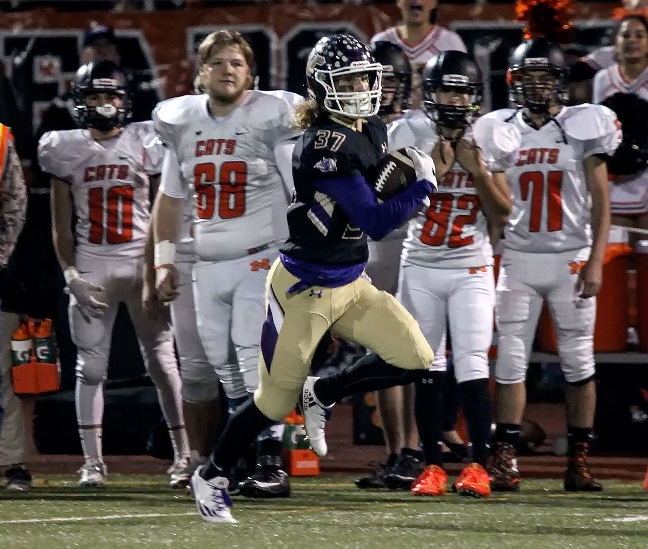 Lake Stevens’ Hunter Eckstrom races for the end zone with members of Monroe looking on during a game Friday at Lake Stevens High School. (Kevin Clark / The Herald)