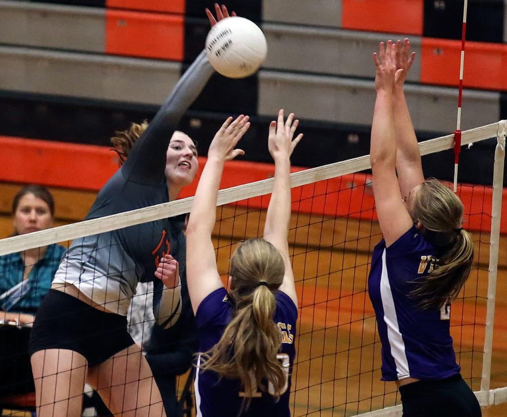 Monroe’s Samantha Zimmerman attempts a kill with Lake Stevens’ Anna Saack (left) and Lilly Eason blocking during the Bearcats’ five-set loss to the Vikings on Thursday in Monroe. (Kevin Clark / The Herald)
