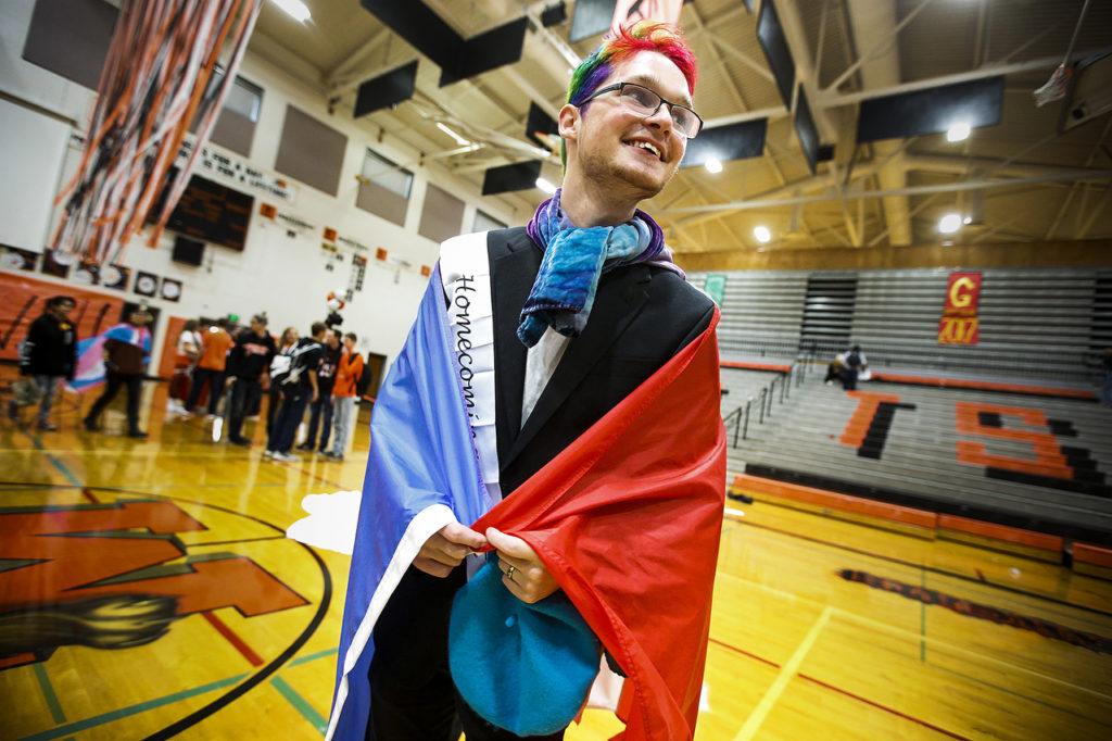 Homecoming nominee Alaric Ganger sports a French flag and multicolor hair as he walks out of the Monroe High School gym following the school’s homecoming kickoff assembly on Friday morning. Ganger was one of two homecoming nominees from Monroe High School’s French Club. (Ian Terry / The Herald)
