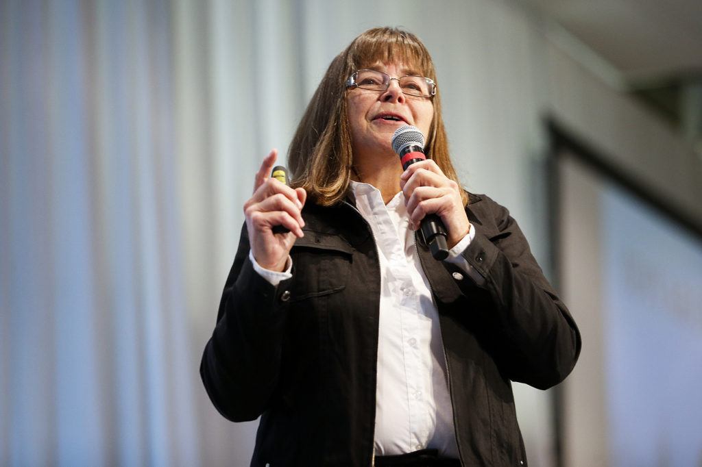 Jan Steves speaks at the 11th annual Domestic Violence Services of Snohomish County luncheon at Xfinity Arena in Everett on Wednesday. Steves, originally from Edmonds, now lives in Alaska and ran her first Iditarod sled dog race in 2012. (Ian Terry / The Herald)
