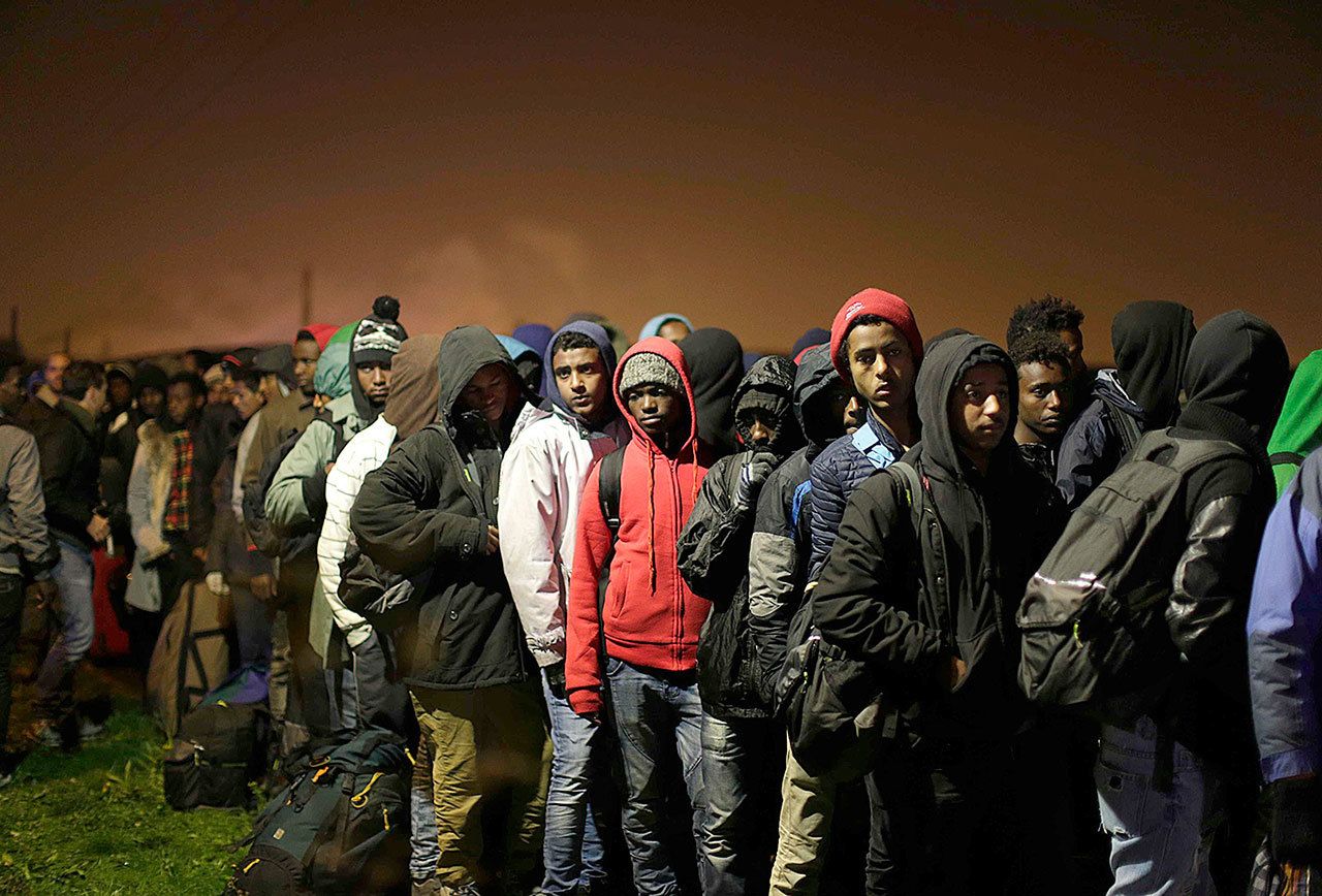 Migrants line-up to register at a processing center in the makeshift migrant camp known as “the jungle” near Calais, northern France, on Monday, Oct. 24. French authorities say the closure of the slum-like camp in Calais will start on Monday and will last approximatively a week in what they describe as a “humanitarian” operation. (AP Photo/Emilio Morenatti)