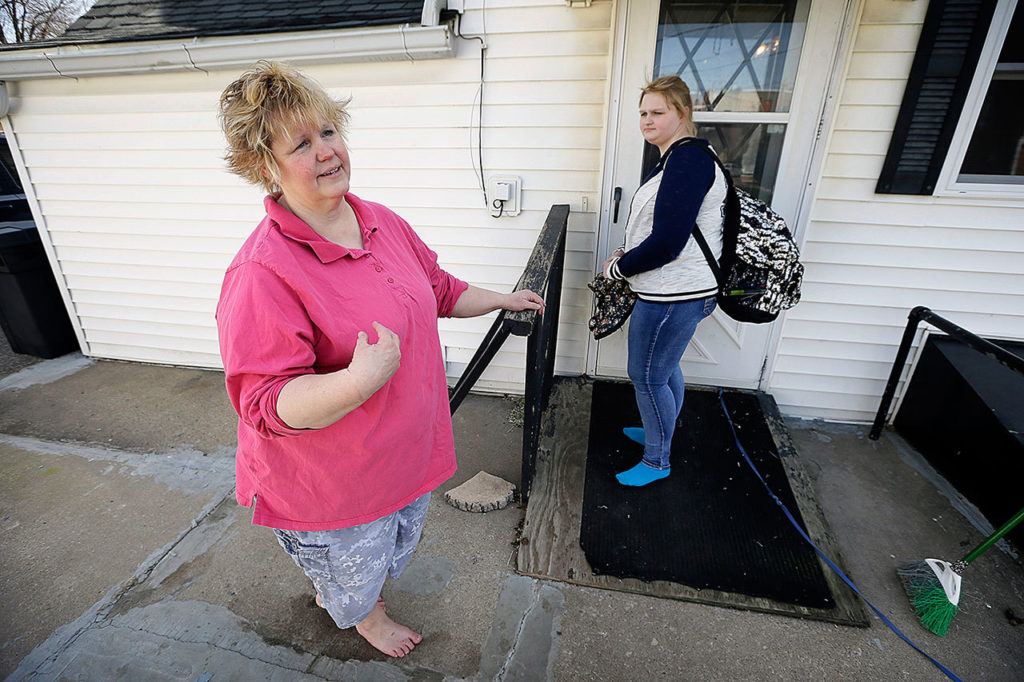 In this April 14, 2016, photo, Denise Kirchner and her daughter, Madison, right, talk about an accidental shooting a few days before Thanksgiving 2015, in their home in Toledo, Iowa. (AP Photo/Charlie Neibergall)
