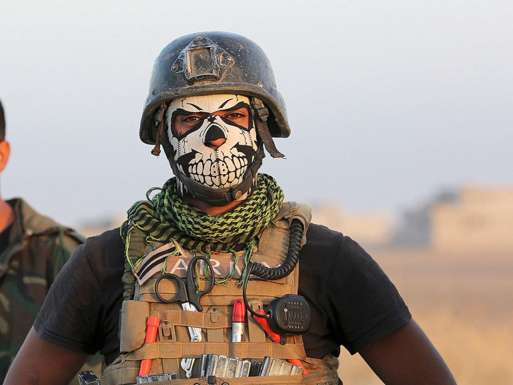 A member of Iraq’s elite counterterrorism forces stands as they advance towards the city of Mosul, Iraq, on Thursday, Oct. 20. Iraqi special forces charged into the Mosul battle Thursday with a pre-dawn advance on a nearby town held by the Islamic State group, a key part of a multi-pronged assault on eastern approaches to the besieged city. (AP Photo/Khalid Mohammed)
