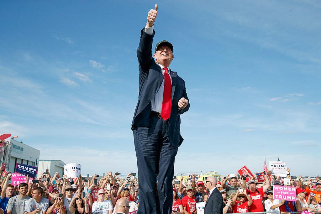 Republican presidential candidate Donald Trump gestures as he arrives to speak to a campaign rally, Tuesday, Oct. 25, in Sanford, Florida. (AP Photo/ Evan Vucci)
