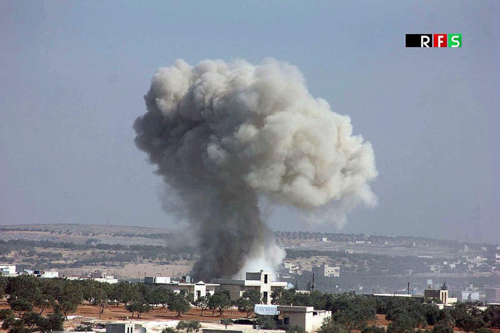 This photo shows an airstrike that killed over 20 people in the village of Hass, Syria, on Wednesday, Oct 26. A team of first responders, the Syrian Civil Defense in Idlib, said at least 50 were wounded in the raids that used parachute mines, targeting the residential area and schools in the village of Hass. Most of those killed were children, the group said on its Facebook page. (Revolutionary Forces of Syria, via AP)
