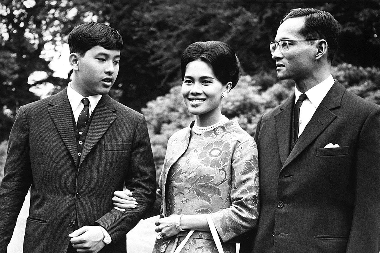 In this July 27, 1966, photo, Thailand’s King Bhumibol Adulyadej, right, walks with Queen Sirikit and their 13-year-old son, Crown Prince Vajiralongkorn, through the gardens of their residence at Sunninghill, Berkshire, where they were staying during a visit to Britain. Crown Prince Maha Vajiralongkorn has been anointed Thailand’s next monarch following his father’s death. (AP Photo/Harris, File)
