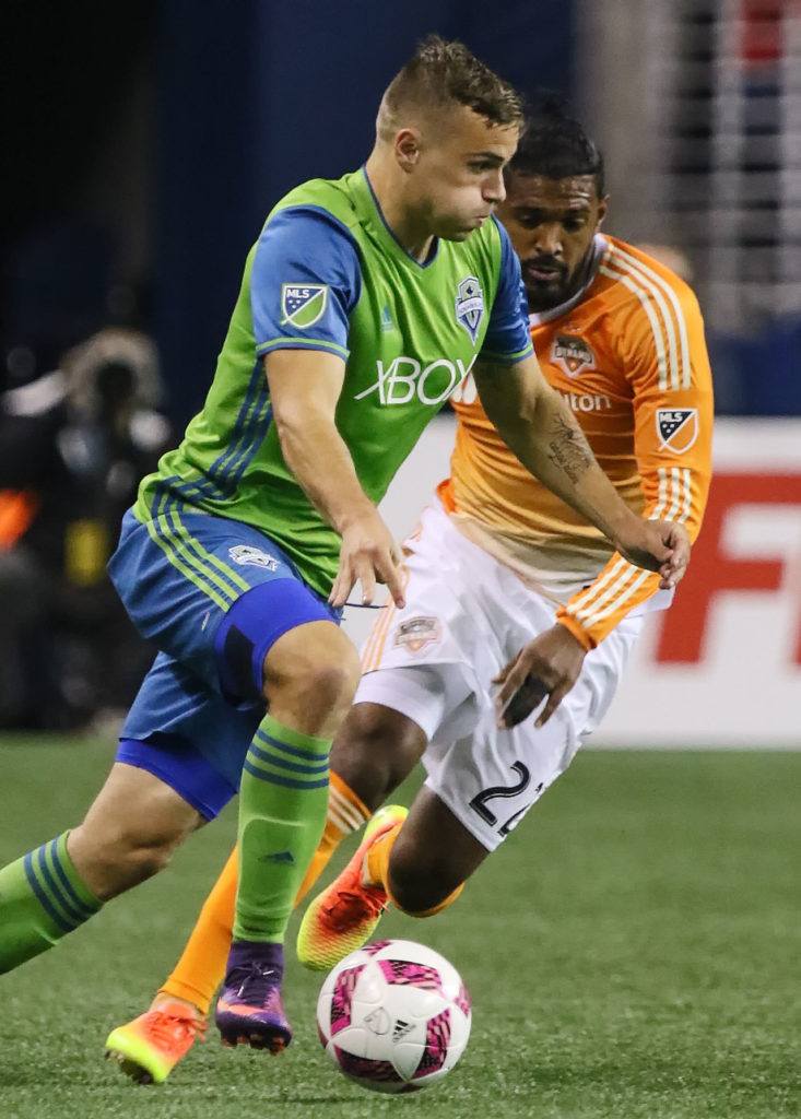 The Sounders’ Jordan Morris controls the ball with the Dynamo’s Sheanon Williams trailing Wednesday night at Century Link Field in Seattle. (Kevin Clark / The Herald)
