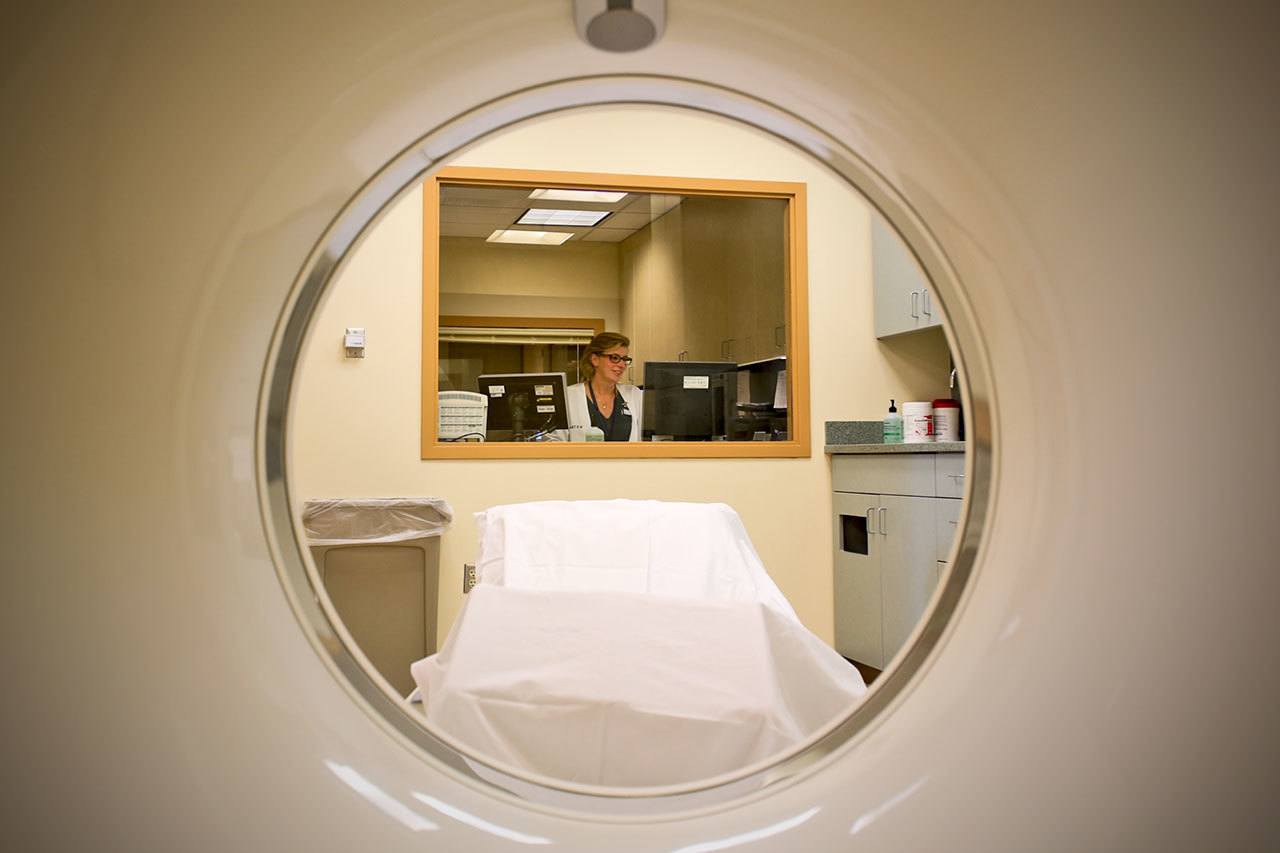 Rita Mangum, 21-year CT technologist at her station at the newly opened Western Washington Medical Group imaging center also host a MRI machine and soon to be installed x-ray machine in Everett. (Kevin Clark / The Herald)