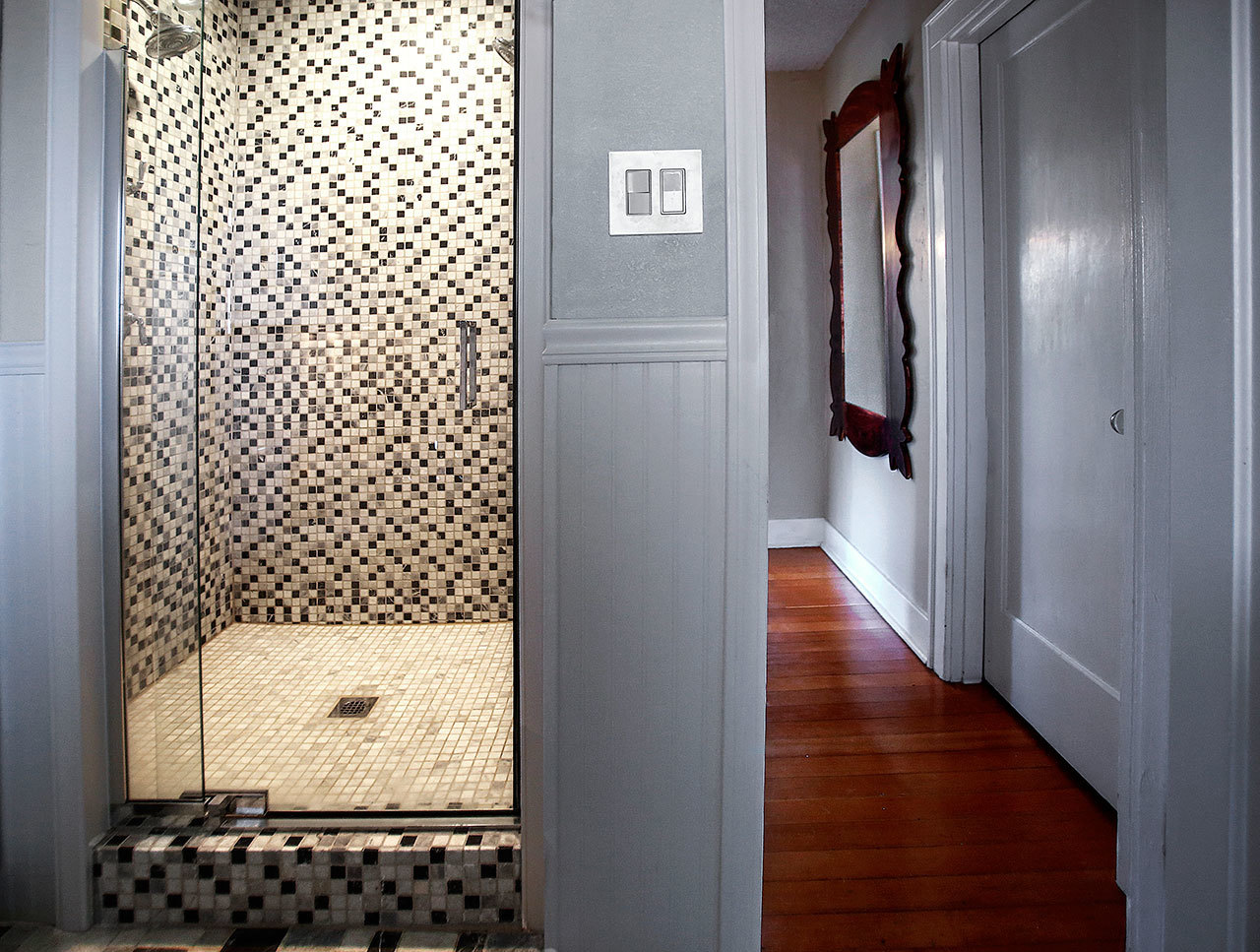 A tiled walk-in shower is a focal point in the bathroom. (Dan Bates / The Herald)
