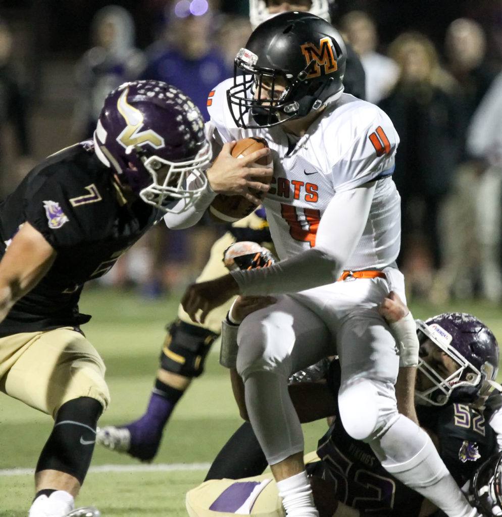 Lake Stevens’ Austin Calvin (left) and Zack Kylany work to sack Monroe’s Zach Zimmerman during a game Friday at Lake Stevens High School. (Kevin Clark / The Herald)

