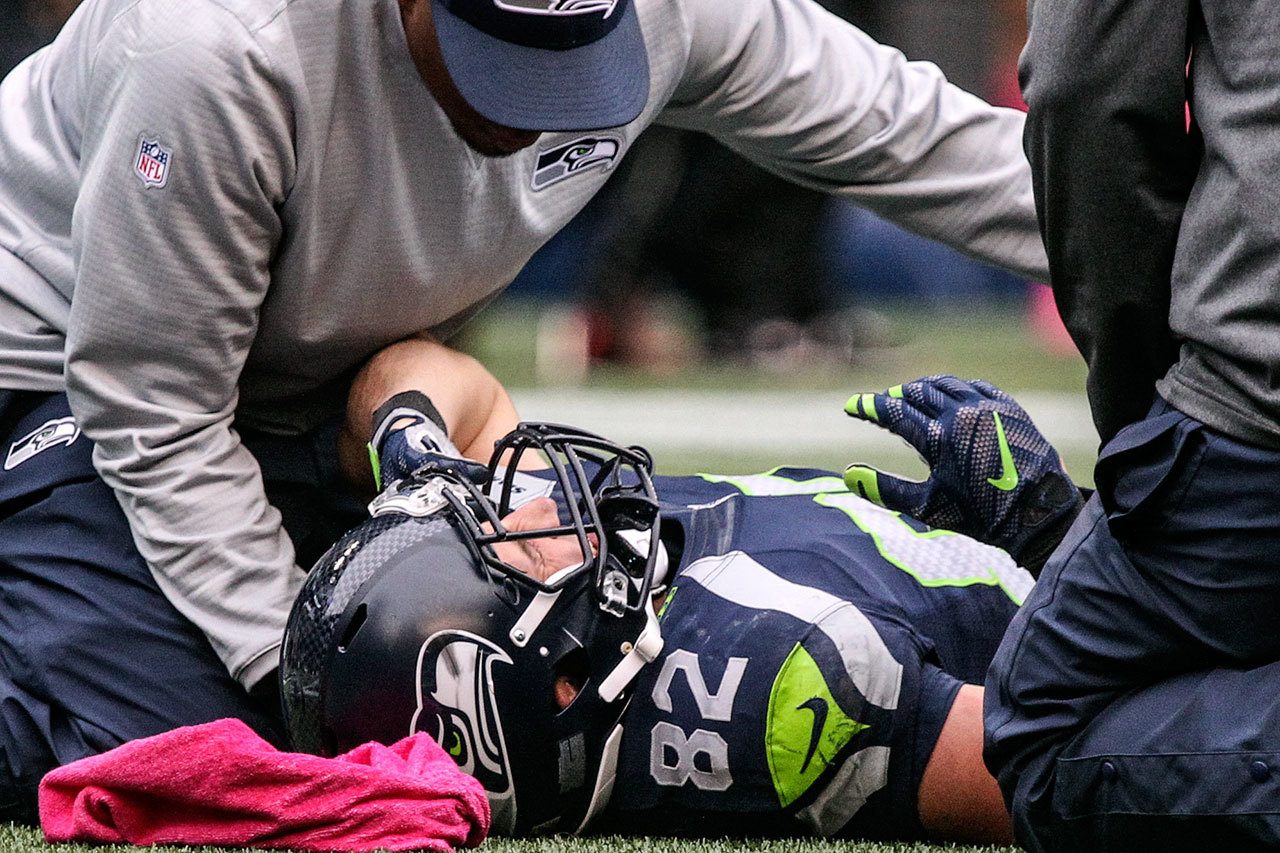 Seahawks tight end Luke Willson is examined after being injured during a 26-24 win over the Falcons this past Sunday at CenturyLink Field in Seattle. (Kevin Clark / The Herald)