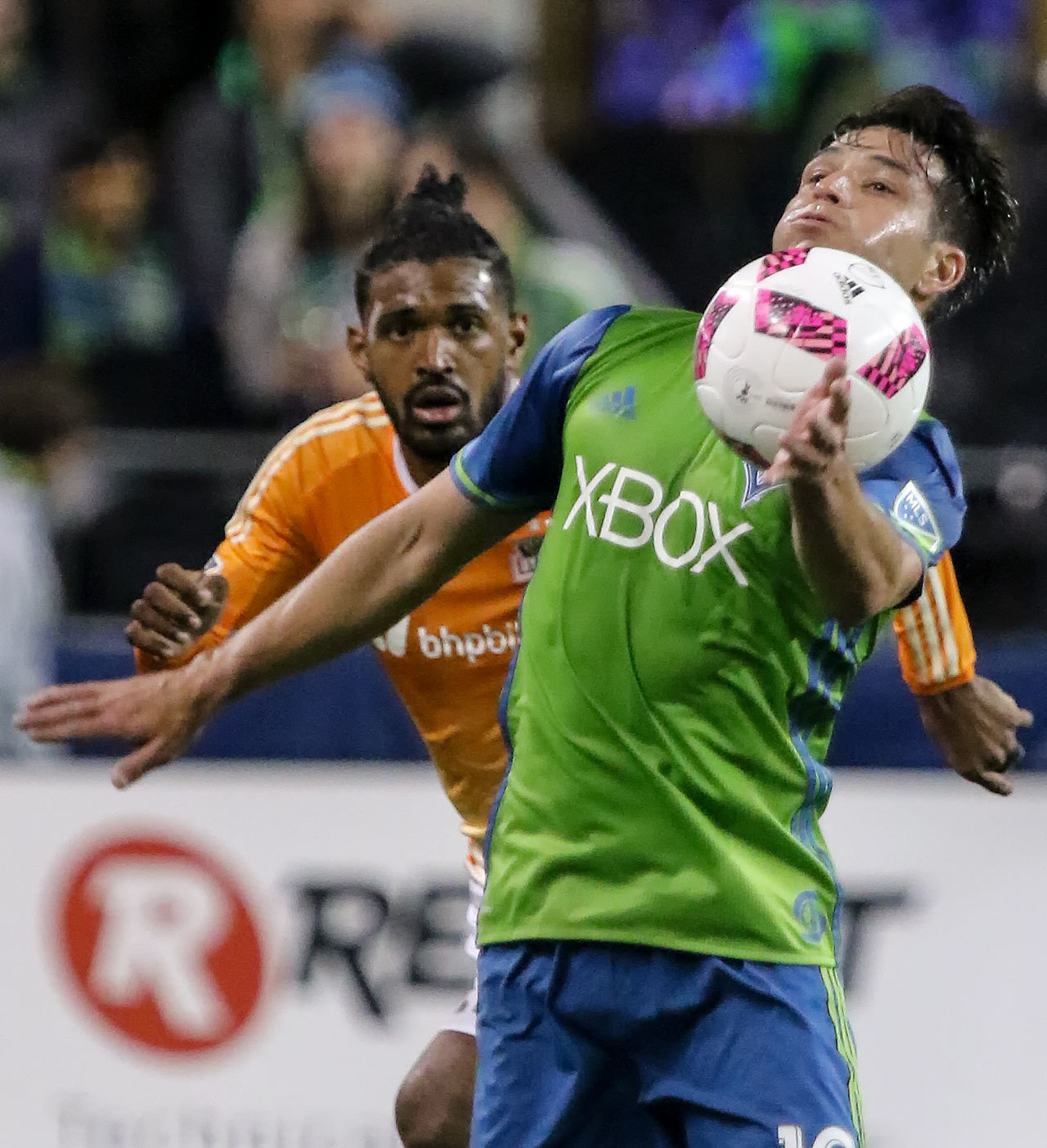 The Sounders’ Nicolas Lodeiro controls the ball with the Dynamo’s Sheanon Williams trailing Wednesday night at Century Link Field in Seattle. (Kevin Clark / The Herald)
