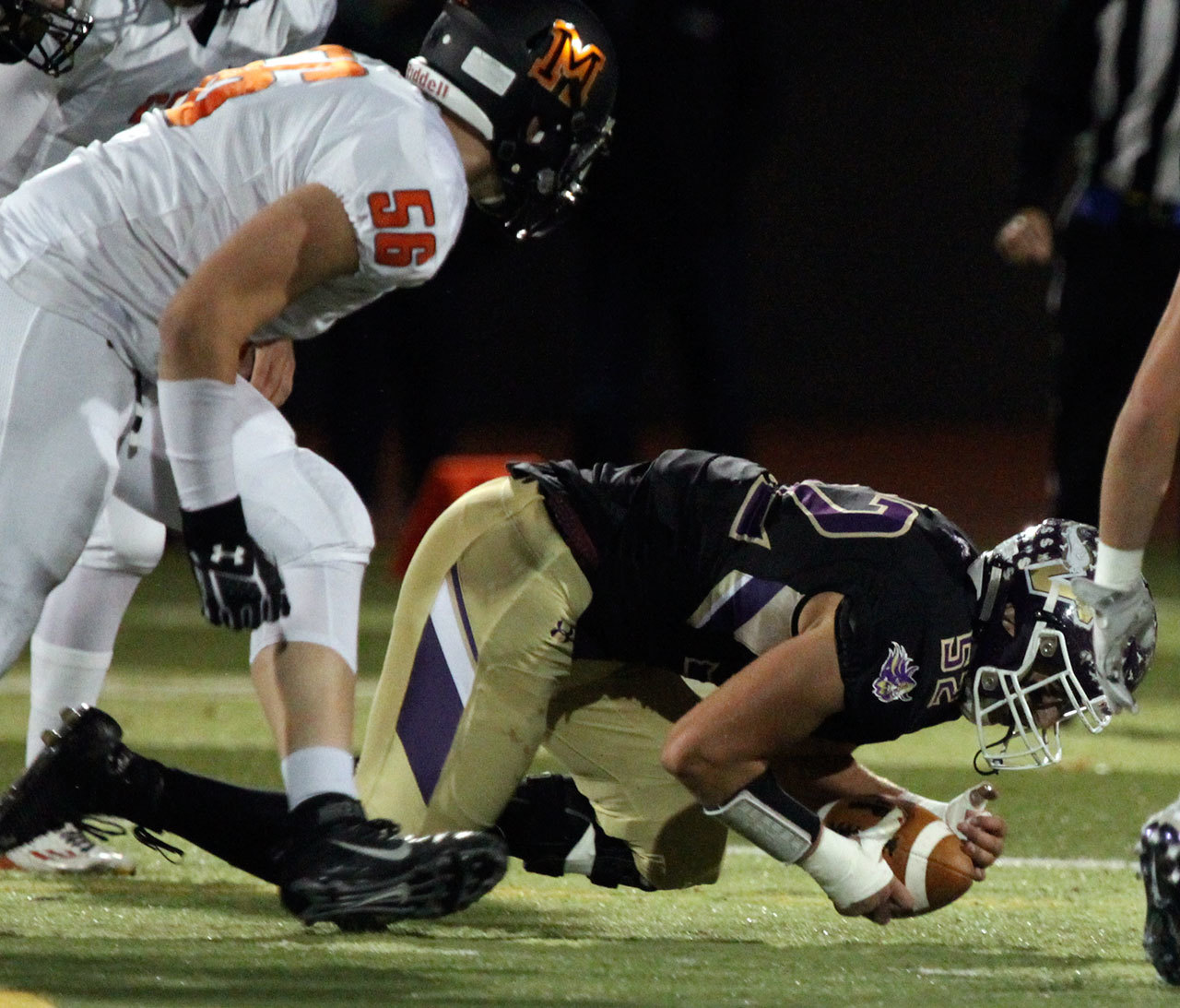 Lake Stevens’ Zack Kylany recovers a fumble with Monroe’s Peyton McMahon trailing during a game Friday at Lake Stevens High School. (Kevin Clark / The Herald)
