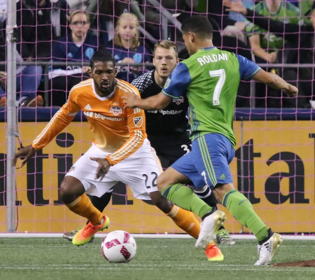 The Sounders’ Cristian Roldan makes a run at the goal with the Dynamo’s Sheanon Williams (left) and Joe Willis (center) defending Wednesday night at Century Link Field in Seattle. (Kevin Clark / The Herald)
