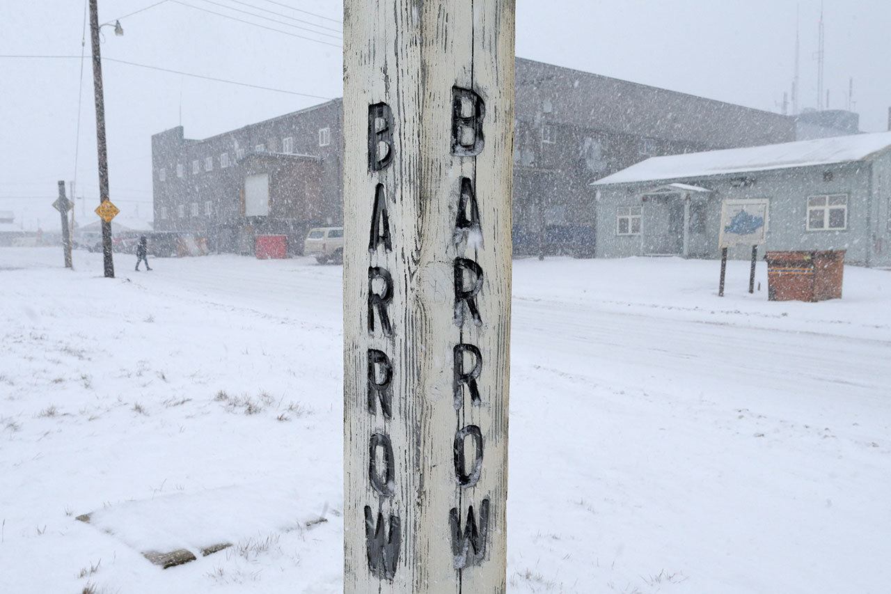 Snow falls around a sign in Barrow, Alaska, in 2014. Residents in Barrow, the nation’s northernmost community, have voted to change the name of their city back to its traditional Inupiaq name of Utqiagvik. (Gregory Bull / Associated Press, File)