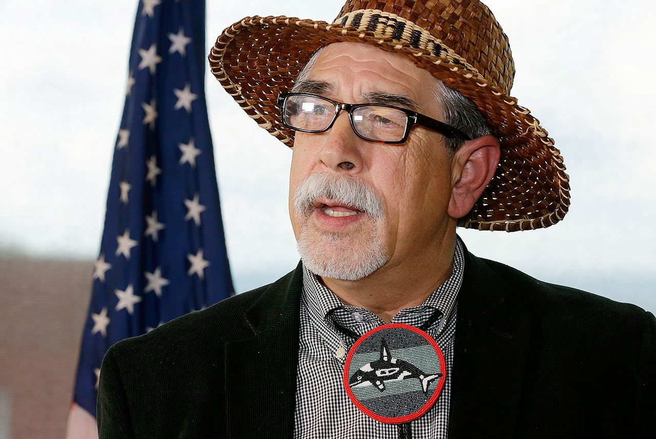 Mel Sheldon Jr., chairman of the Tulalip tribe, wears the beaded image of a killer whale, or Orca, as he speaks Tuesday at a press conference in Seattle. Sheldon was discussing the formation of a new federal task force announced Tuesday to identify restoration priorities for Puget Sound, one of the nation’s largest estuaries. (AP Photo / Ted S. Warren)