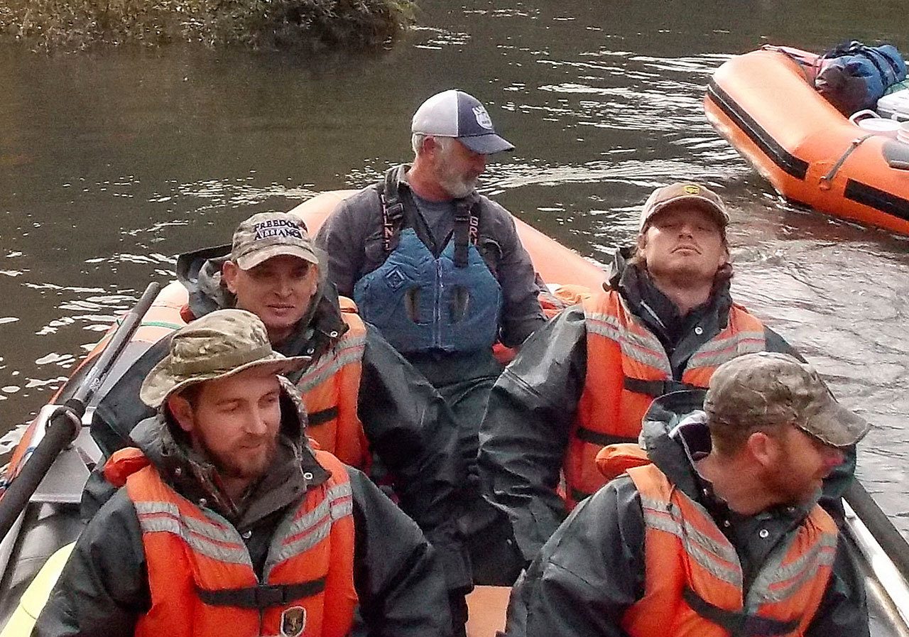 Guide Bill Inkrote and veterans (from left) Tate Landin, Mark Deleon, Grandon Glenn and Hadley Henderson shove off at Grave Creek boat landing on the middle Rogue River on Oct. 20 for a three-day raft trip with the Freedom Alliance, a program to help veterans heal in Galice, Oregon. (Jeff Duewel / The Daily Courier)