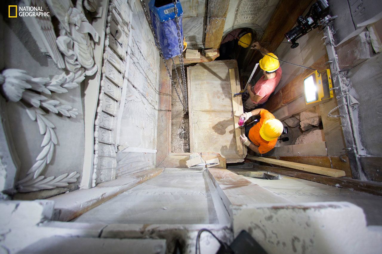 Workers remove the top marble layer of the tomb said to be of Jesus Christ, in the Church of Holy Sepulcher in Jerusalem on Wednesday. (Dusan Vranic / National Geographic)