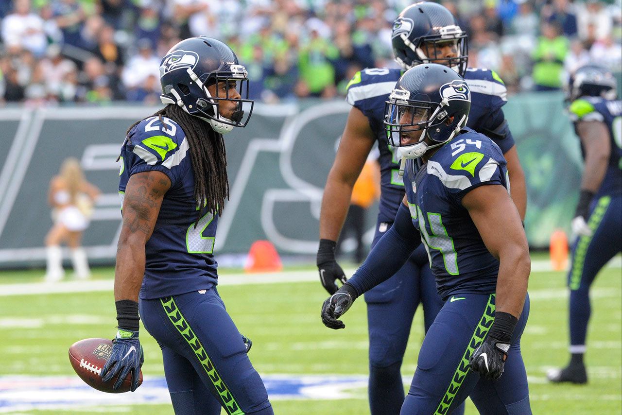 Seattle Seahawks cornerback Richard Sherman (left) celebrates with linebacker Bobby Wagner after Sherman intercepted a pass in the second half of Sunday’s game in East Rutherford, N.J. (AP Photo/Bill Kostroun)