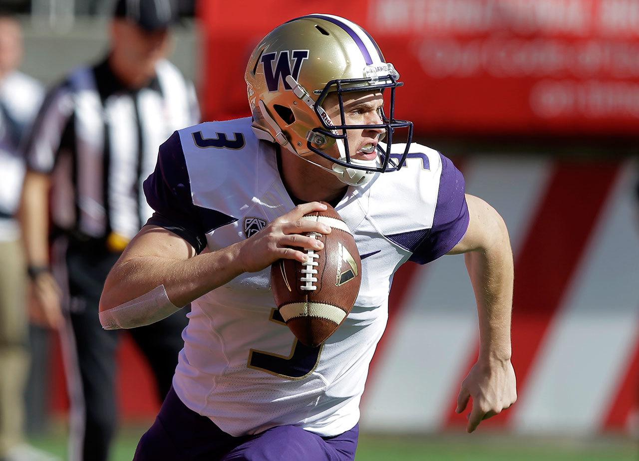 Washington quarterback Jake Browning (3) rolls out as he looks down field in the first half of a game against Utah this past Saturday in Salt Lake City. (AP Photo/Rick Bowmer)
