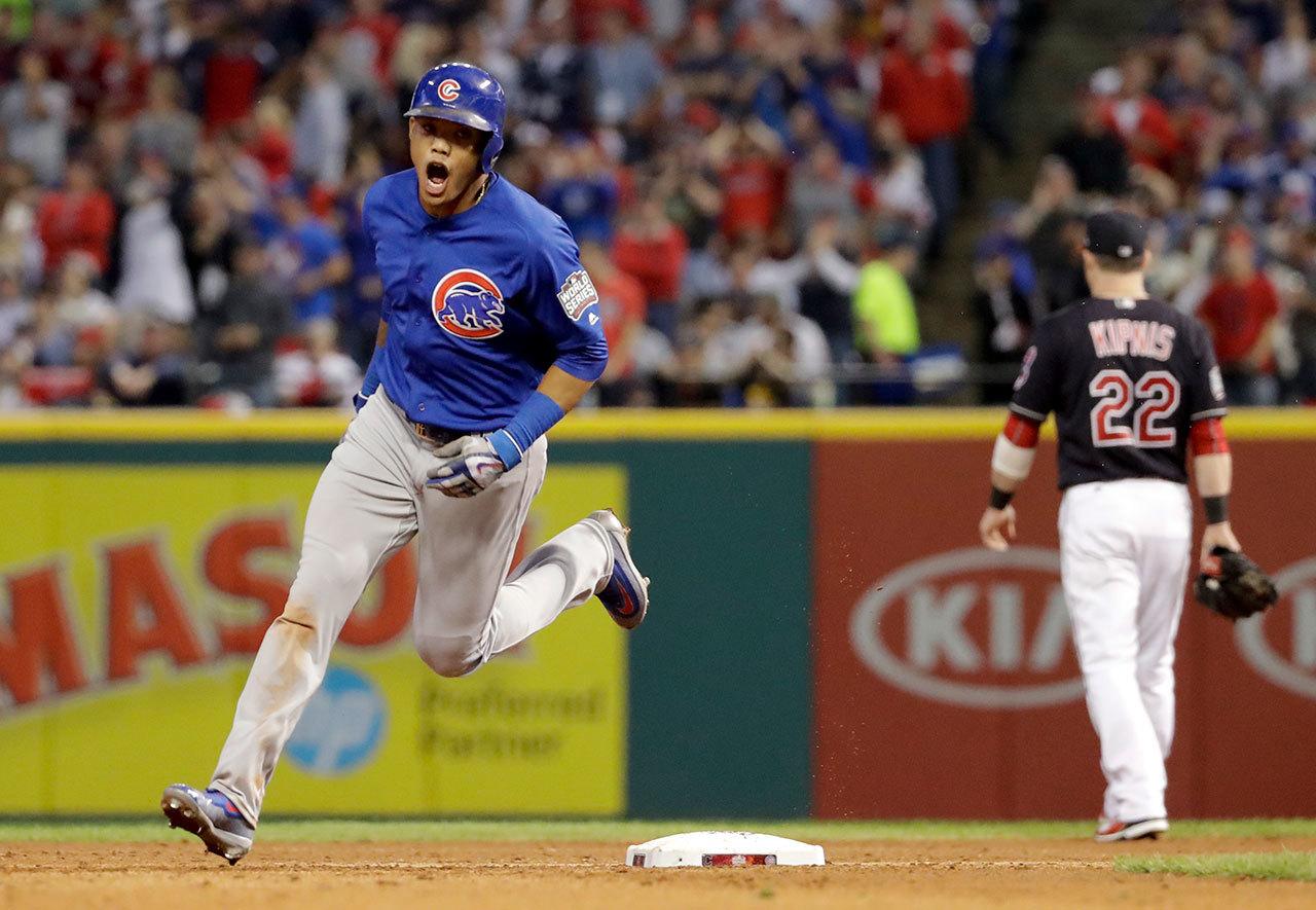 The Cubs’ Addison Russell celebrates after his grand slam against the Indians during the third inning of Game 6 of the World Series on Tuesday in Cleveland. (AP Photo/Matt Slocum)