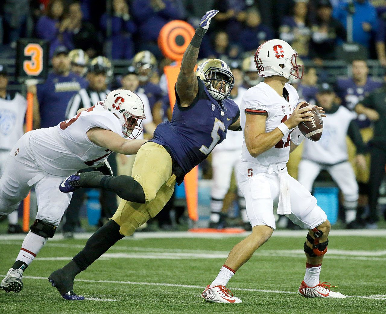 Washington linebacker Joe Mathis (5), shown here against Stanford on Sept. 30, will miss the remainder of the Huskies’ season with a foot injury. (AP Photo/Ted S. Warren)